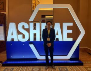 Man standing in front of the conference logo